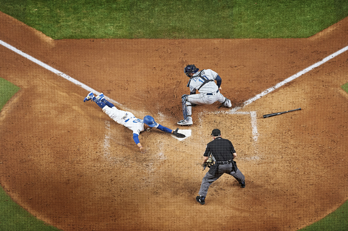 Dodgers’ Mookie Betts slides headfirst into home plate ahead of a tag from Rays catcher Mike Zunino during the 2020 World Series